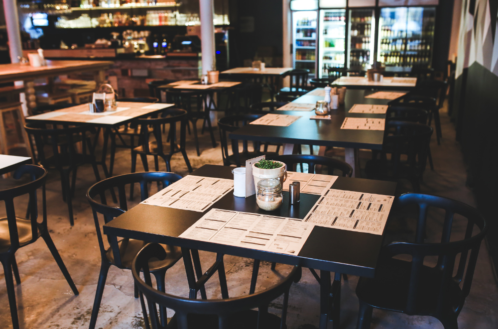 Restaurant with tables and chairs with menu on table